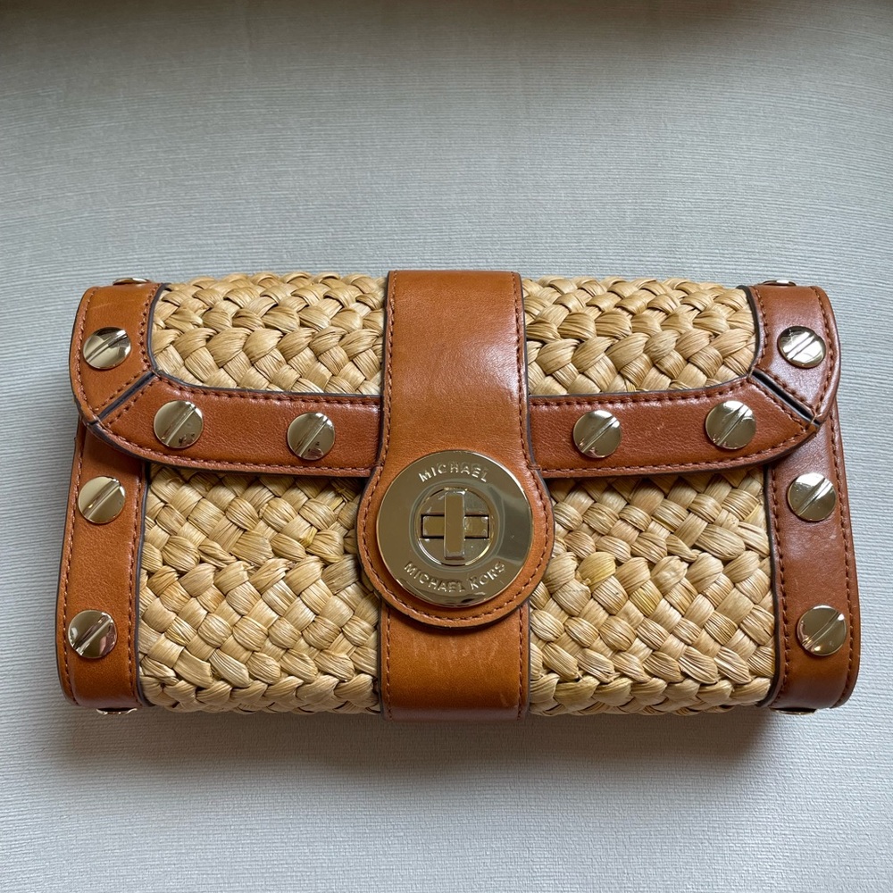Michael Kors wicker and brown leather purse.